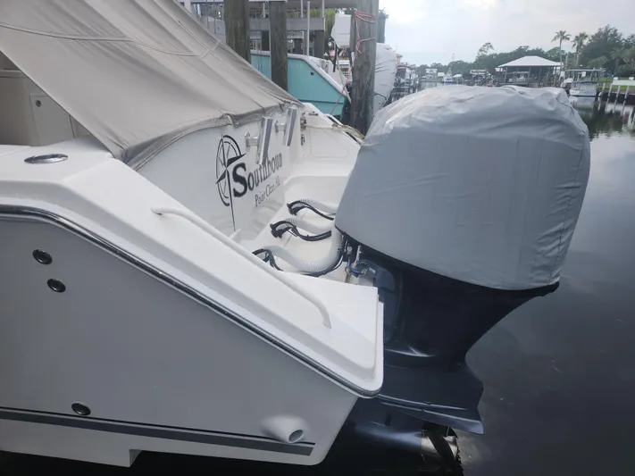 Yacht Photos Pics 2015 Jupiter 41 SB boat docked, featuring covered outboard motor and "Southbound" branding.