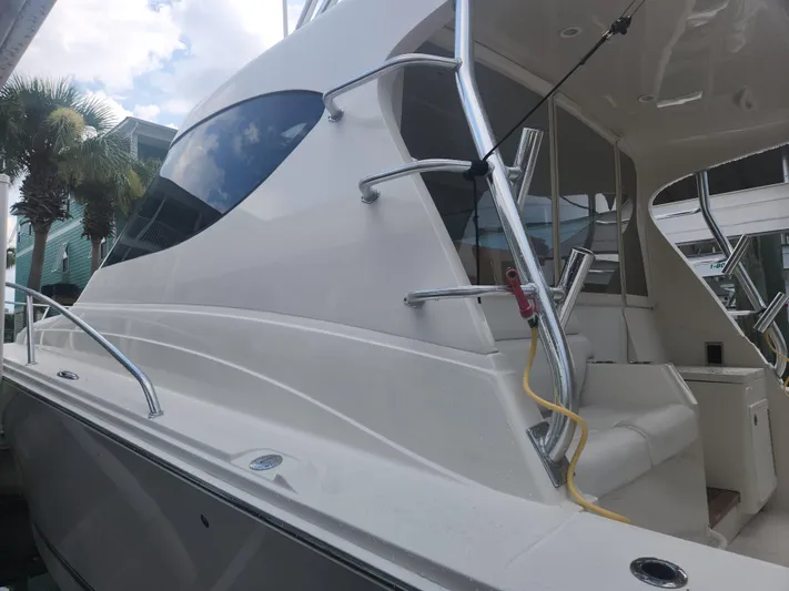  Yacht Photos Pics 2015 Jupiter 41 SB boat with sleek design and modern features, docked near palm trees.