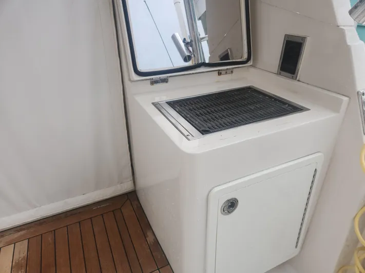  Yacht Photos Pics Outdoor grill station on 2015 Jupiter 41 SB boat with wooden deck flooring.