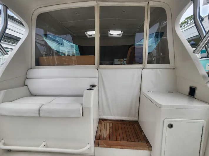  Yacht Photos Pics Interior view of 2015 Jupiter 41 SB boat with white seating and wooden flooring.