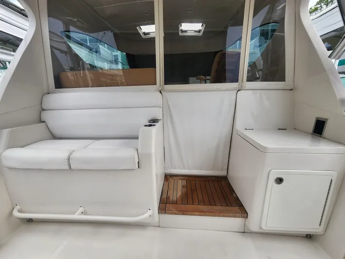  Yacht Photos Pics Interior of a 2015 Jupiter 41 SB boat with white seating and wooden flooring.
