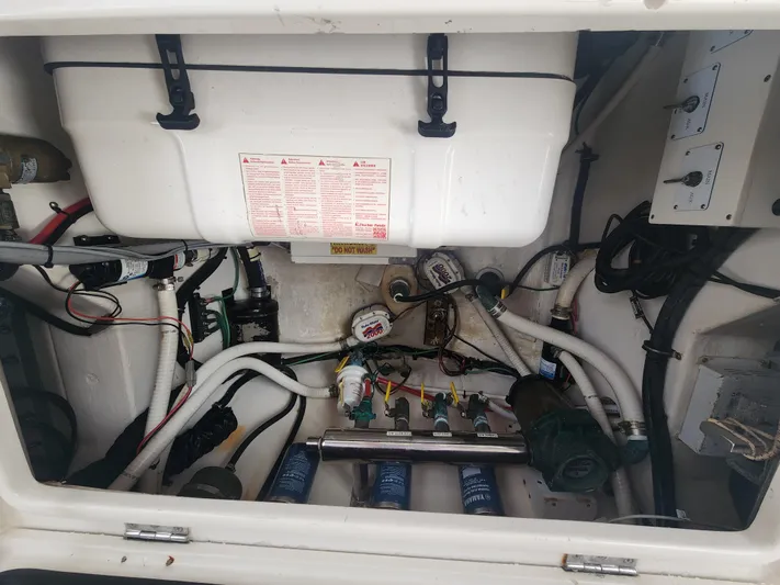  Yacht Photos Pics Engine compartment of a 2015 Jupiter 41 SB boat, showcasing various mechanical components.