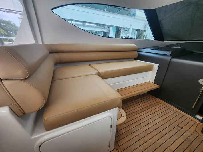  Yacht Photos Pics Luxurious interior seating of 2015 Jupiter 41 SB yacht with tan leather and wood flooring.