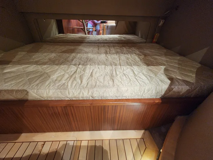  Yacht Photos Pics Interior cabin of 2015 Jupiter 41 SB with a neatly made bed.