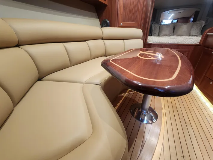  Yacht Photos Pics Luxurious interior of 2015 Jupiter 41 SB yacht with leather seating and wooden table.