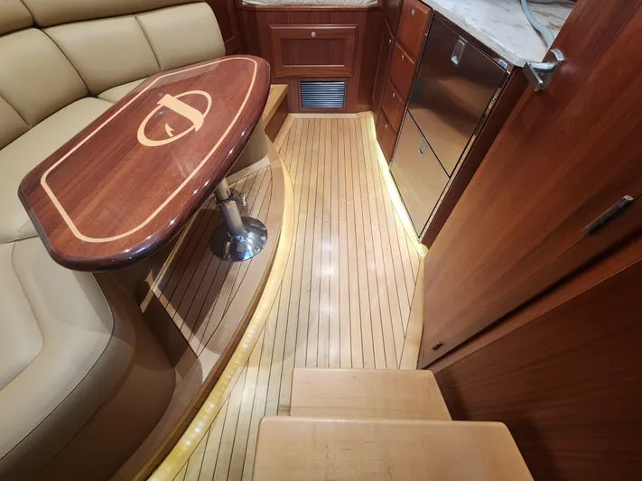 Yacht Photos Pics Luxurious interior of 2015 Jupiter 41 SB yacht with elegant wood finishes and seating.
