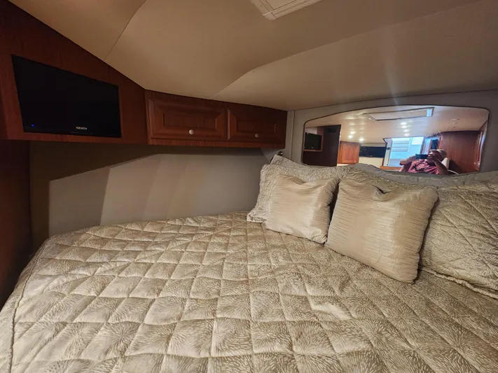  Yacht Photos Pics Luxurious cabin interior of 2015 Jupiter 41 SB with plush bedding and wooden cabinetry.