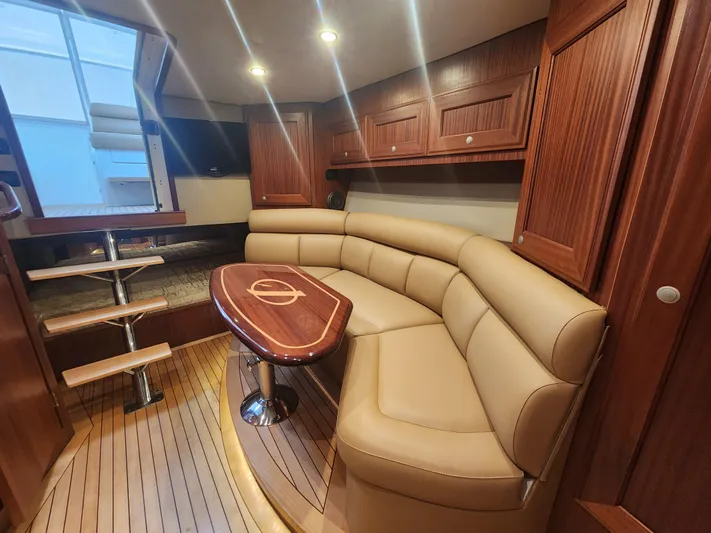  Yacht Photos Pics Luxurious interior of 2015 Jupiter 41 SB yacht with leather seating and wooden cabinetry.
