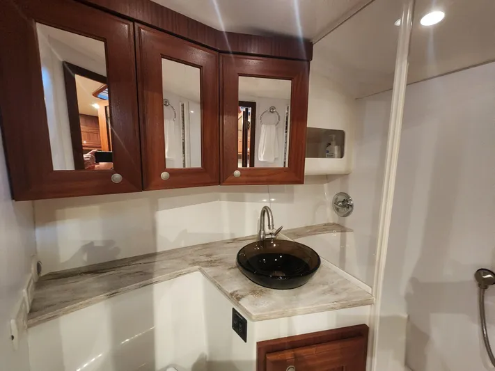  Yacht Photos Pics Luxurious bathroom interior of 2015 Jupiter 41 SB yacht with elegant wood cabinetry.