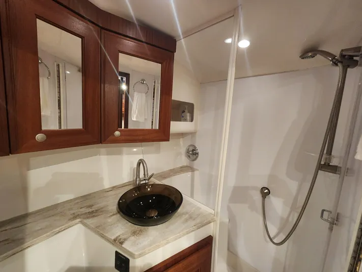  Yacht Photos Pics Luxurious bathroom in 2015 Jupiter 41 SB yacht with modern fixtures and wooden cabinetry.