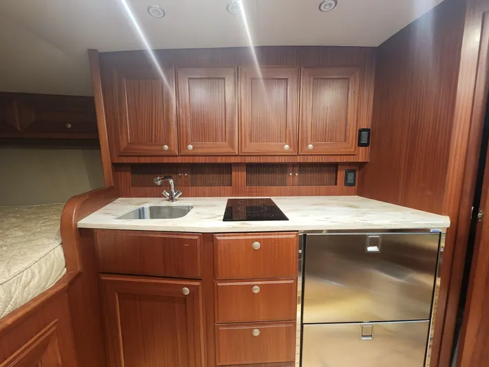  Yacht Photos Pics Luxurious wooden kitchen interior of 2015 Jupiter 41 SB yacht with modern appliances.