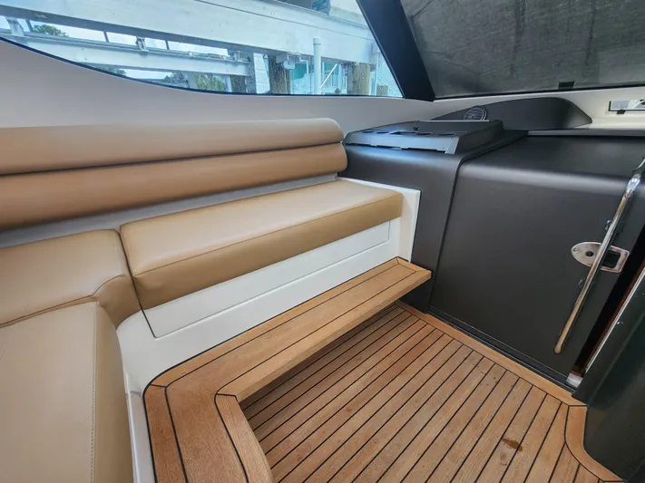  Yacht Photos Pics Luxurious interior of 2015 Jupiter 41 SB yacht with tan seating and wooden flooring.
