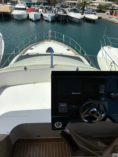  Yacht Photos Pics Guy Couach 1900 yacht, 2018 model, docked in a marina with other boats.