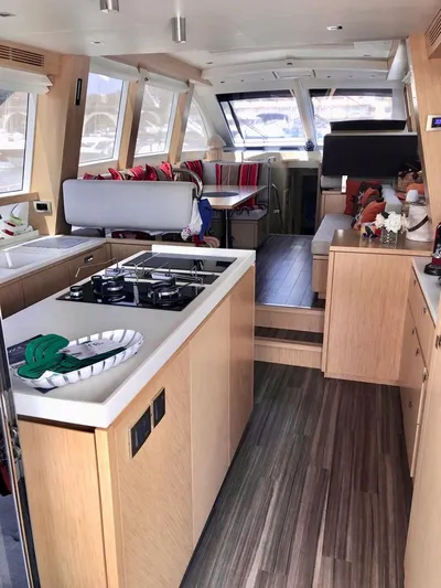  Yacht Photos Pics Luxurious interior of 2018 Guy Couach 1900 yacht with modern kitchen and seating area.