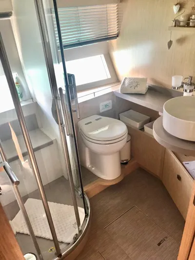  Yacht Photos Pics Modern yacht bathroom with shower, toilet, and sink in a 2018 Guy Couach 1900 model.