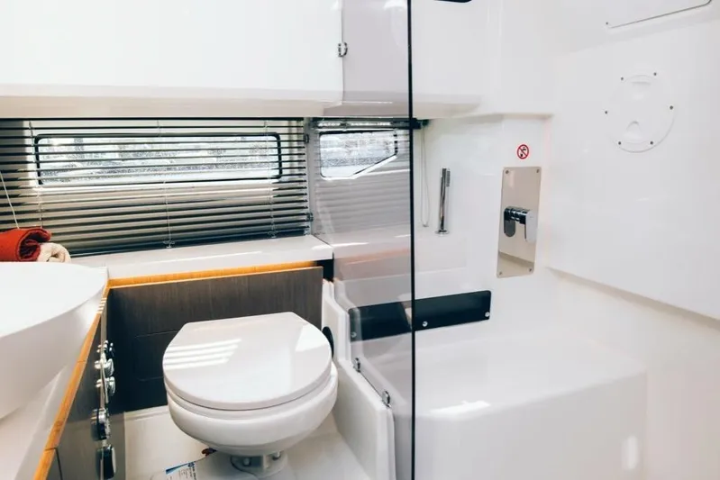  Yacht Photos Pics Modern bathroom interior in 2023 Wellcraft 355 boat, featuring sleek design and compact amenities.