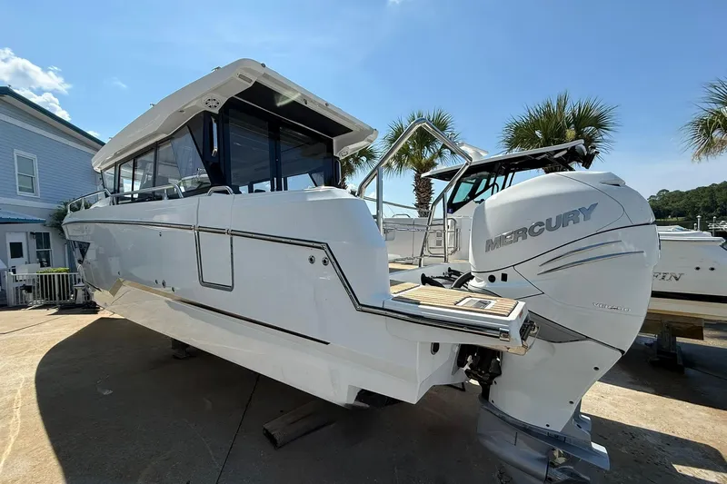  Yacht Photos Pics 2023 Wellcraft 355 boat with Mercury engine, docked under clear blue sky.