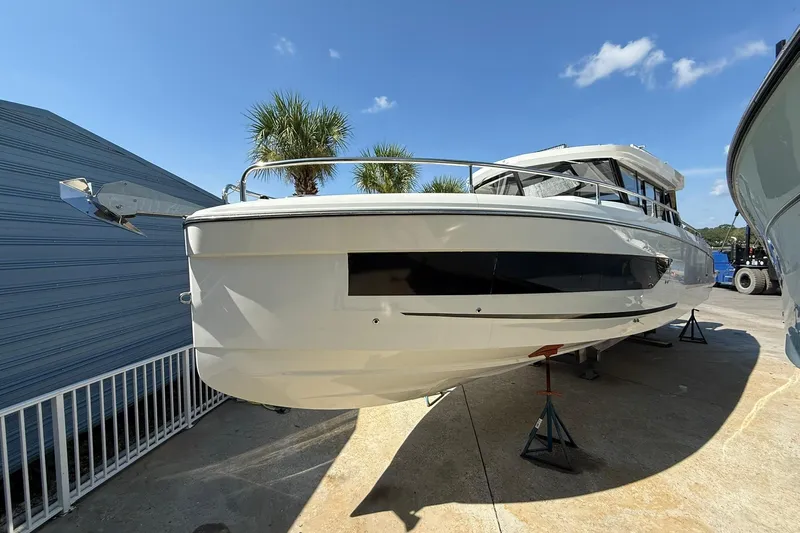  Yacht Photos Pics 2023 Wellcraft 355 boat on stands, outdoor display, sunny day, palm trees in background.