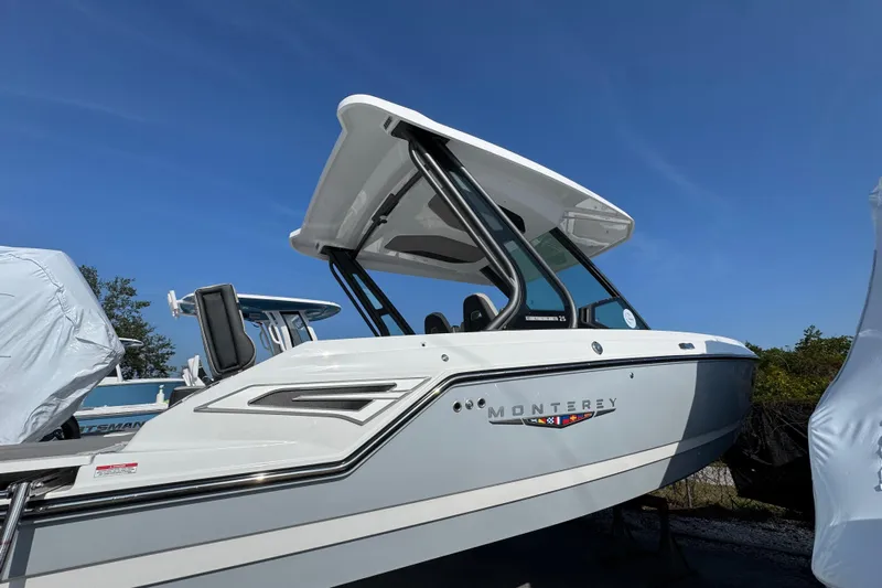  Yacht Photos Pics 2026 Monterey Elite 25 OB boat with sleek design under clear blue sky.