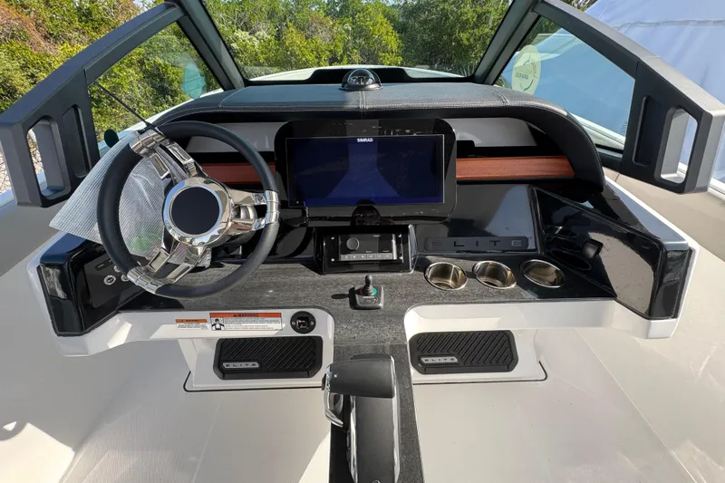  Yacht Photos Pics 2026 Monterey Elite 25 OB boat dashboard with steering wheel and digital display.
