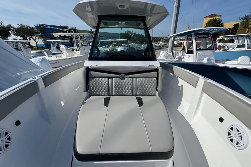  Yacht Photos Pics 2026 Monterey Elite 25 OB boat interior with cushioned seating and modern design.