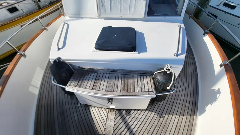 Maia Yacht Photos Pics 1989 Grand Banks 42 Classic yacht deck with wooden flooring and storage compartment.