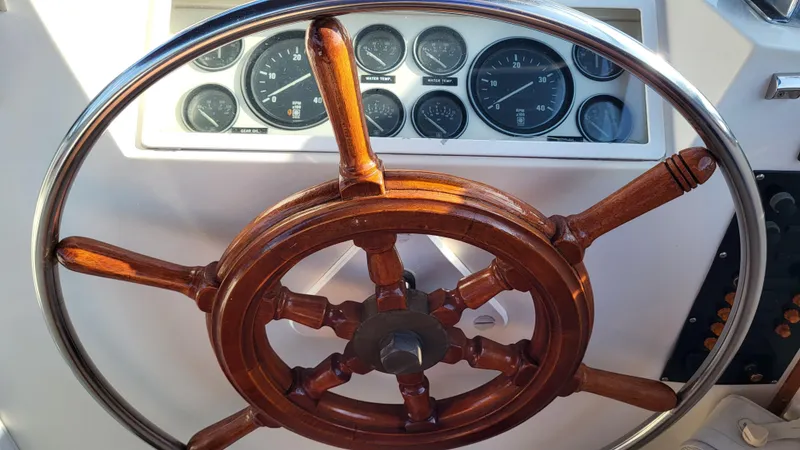 Maia Yacht Photos Pics Wooden steering wheel and gauges on 1989 Grand Banks 42 Classic yacht.