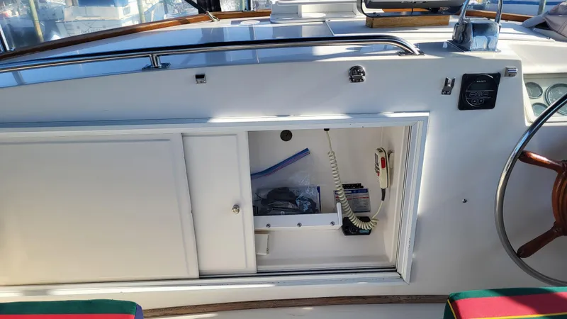 Maia Yacht Photos Pics 1989 Grand Banks 42 Classic yacht helm station with storage compartment open.