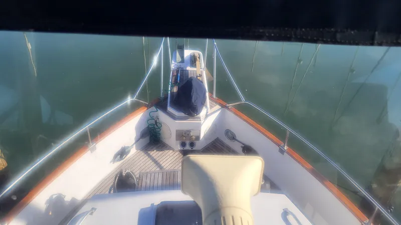 Maia Yacht Photos Pics 1989 Grand Banks 42 Classic yacht deck view with calm water reflection.