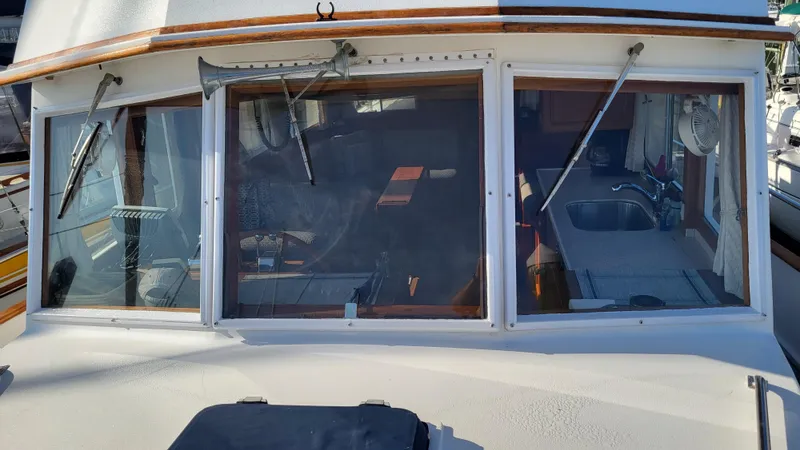 Maia Yacht Photos Pics 1989 Grand Banks 42 Classic yacht cockpit with windows and interior view.