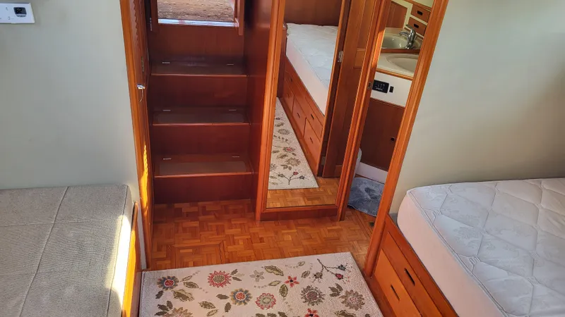Maia Yacht Photos Pics Interior of 1989 Grand Banks 42 Classic yacht with wooden stairs and twin beds.