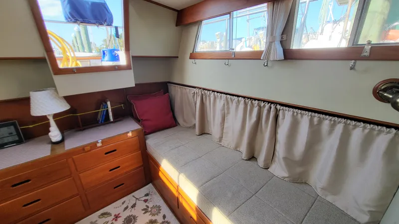 Maia Yacht Photos Pics Cozy interior of 1989 Grand Banks 42 Classic with cushioned seating and wooden cabinetry.