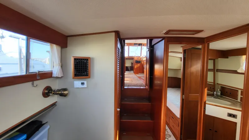 Maia Yacht Photos Pics Interior of 1989 Grand Banks 42 Classic yacht, featuring wood paneling and cozy cabin space.