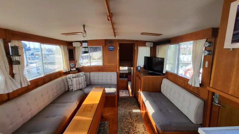 Maia Yacht Photos Pics Interior of 1989 Grand Banks 42 Classic yacht with cozy seating and large windows.