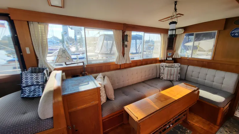Maia Yacht Photos Pics Interior of 1989 Grand Banks 42 Classic yacht with cozy seating and wooden accents.