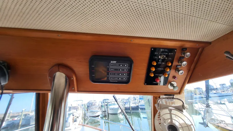 Maia Yacht Photos Pics Interior helm of 1989 Grand Banks 42 Classic yacht with control panels.