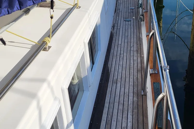 Maia Yacht Photos Pics 1989 Grand Banks 42 Classic yacht with wooden deck and white cabin.