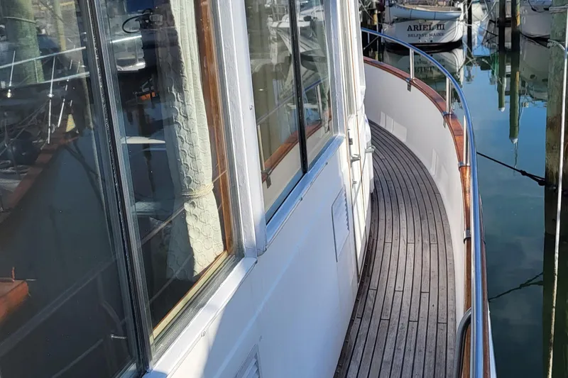 Maia Yacht Photos Pics 1989 Grand Banks 42 Classic yacht with wooden deck, docked in marina.