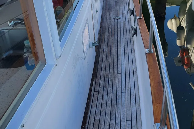 Maia Yacht Photos Pics 1989 Grand Banks 42 Classic yacht with wooden deck and railing, docked at marina.