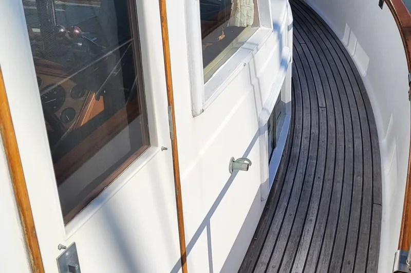 Maia Yacht Photos Pics 1989 Grand Banks 42 Classic yacht with wooden deck and white cabin exterior.