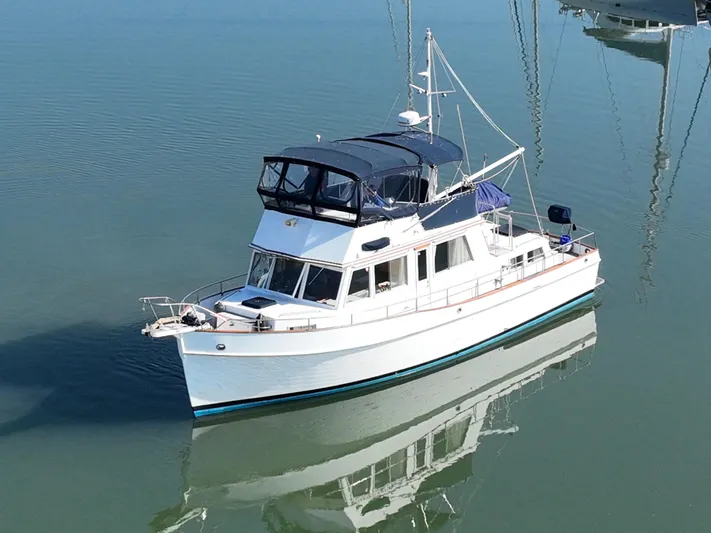 Maia Yacht Photos Pics 1989 Grand Banks 42 Classic yacht on calm water, showcasing elegant design and craftsmanship.