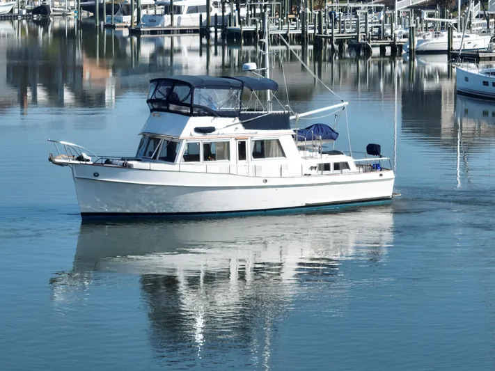 Maia Yacht Photos Pics 1989 Grand Banks 42 Classic yacht on calm marina waters.