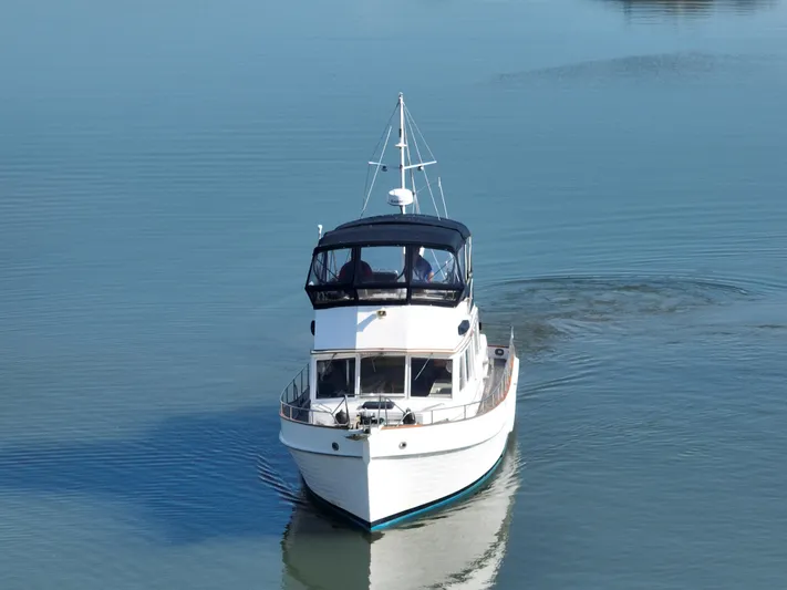 Maia Yacht Photos Pics 1989 Grand Banks 42 Classic yacht cruising on calm water.