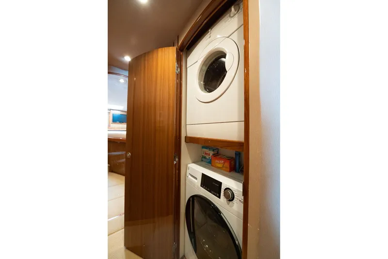 Defiance Yacht Photos Pics Laundry area in 2007 Viking 64 Convertible yacht with stacked washer and dryer.