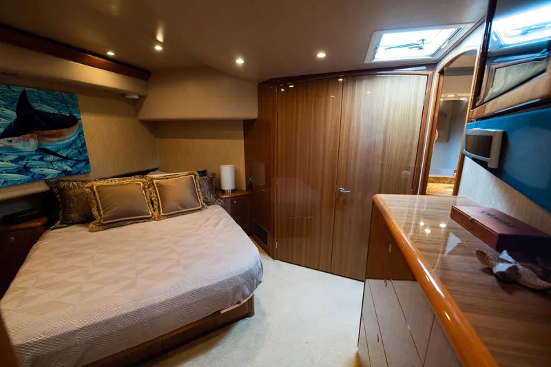 Defiance Yacht Photos Pics Luxurious bedroom interior of 2007 Viking 64 Convertible yacht with elegant wood finishes.