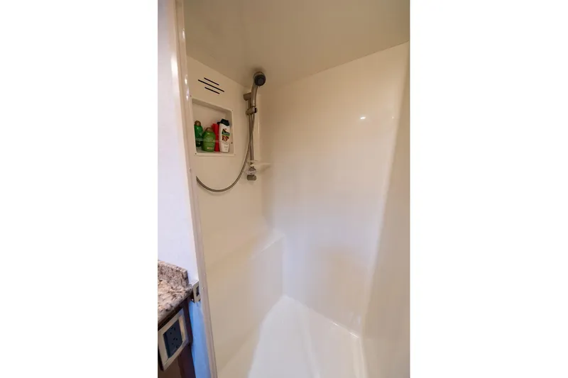 Defiance Yacht Photos Pics Shower area in 2007 Viking 64 Convertible yacht with built-in shelf and handheld showerhead.