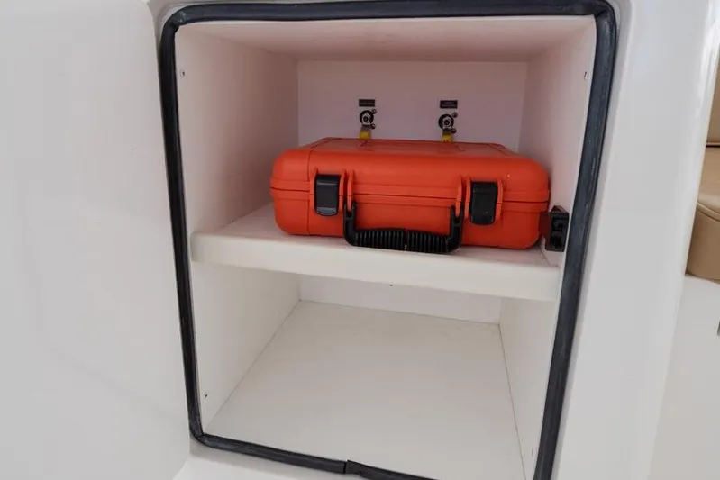 Defiance Yacht Photos Pics Storage compartment on 2007 Viking 64 Convertible with orange case inside.