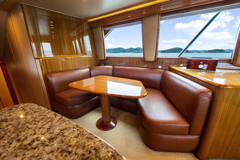 Defiance Yacht Photos Pics Luxurious interior of 2007 Viking 64 Convertible yacht with leather seating and wooden table.