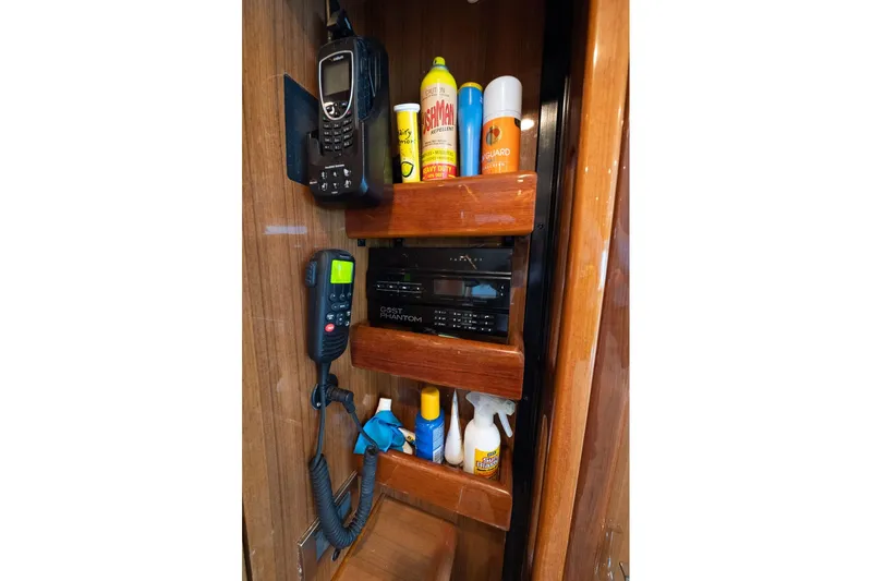 Defiance Yacht Photos Pics 2007 Viking 64 Convertible interior storage with communication devices and cleaning supplies.