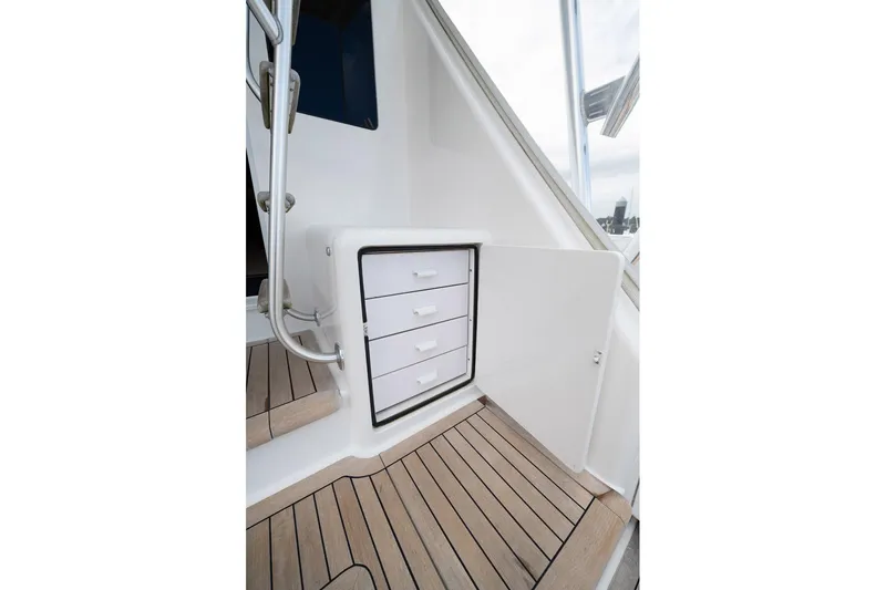 Defiance Yacht Photos Pics 2007 Viking 64 Convertible yacht interior with wooden flooring and storage drawers.